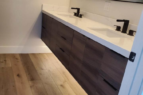 Stylish bathroom featuring wooden floors and white sink.
