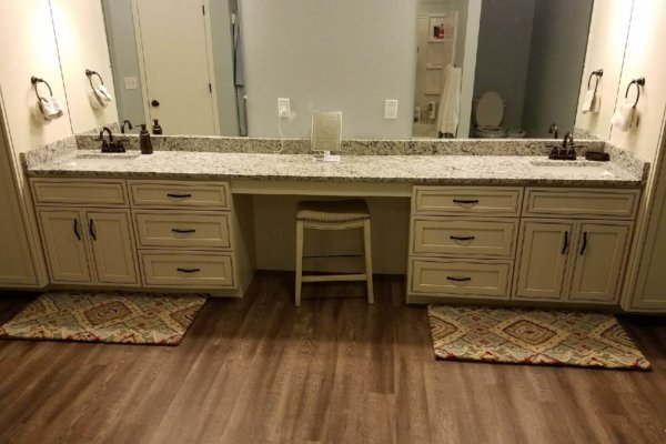 A spacious bathroom featuring two sinks and a vanity.
