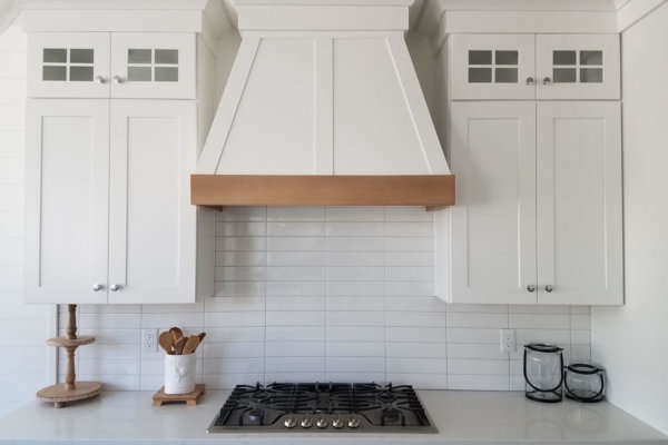 Modern white kitchen featuring stove and oven.