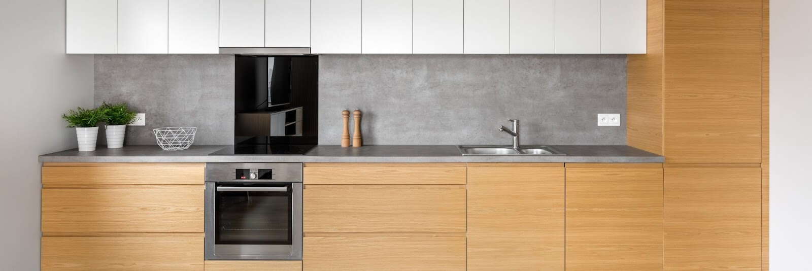 A stylish kitchen with custom wooden cabinets and a polished sink, exemplifying modern aesthetics and practical use.