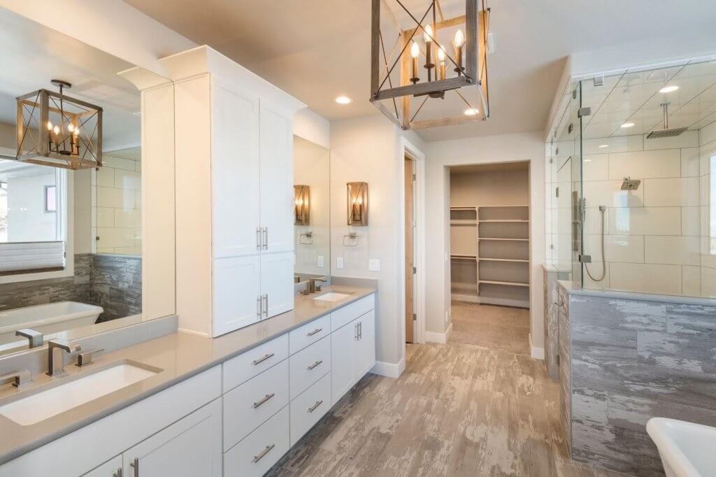 A spacious bathroom with a walk-in shower and double sinks designed for comfort