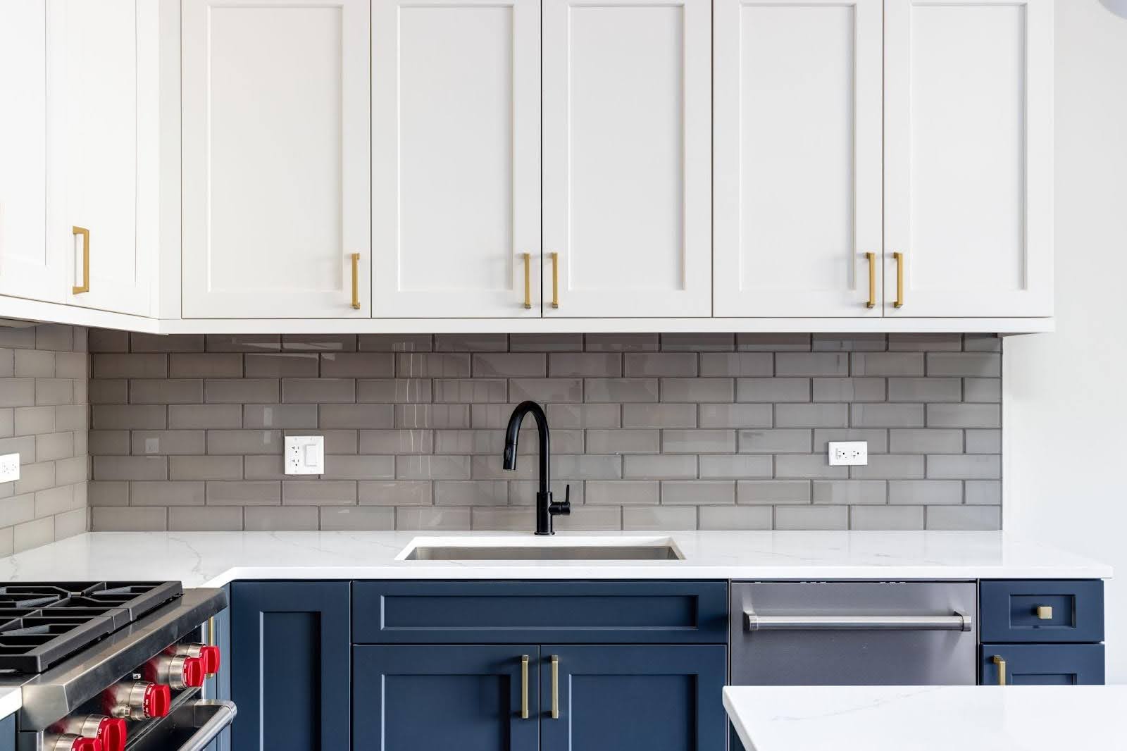 A stylish kitchen showcasing bright blue cabinets paired with pristine white countertops for a fresh look