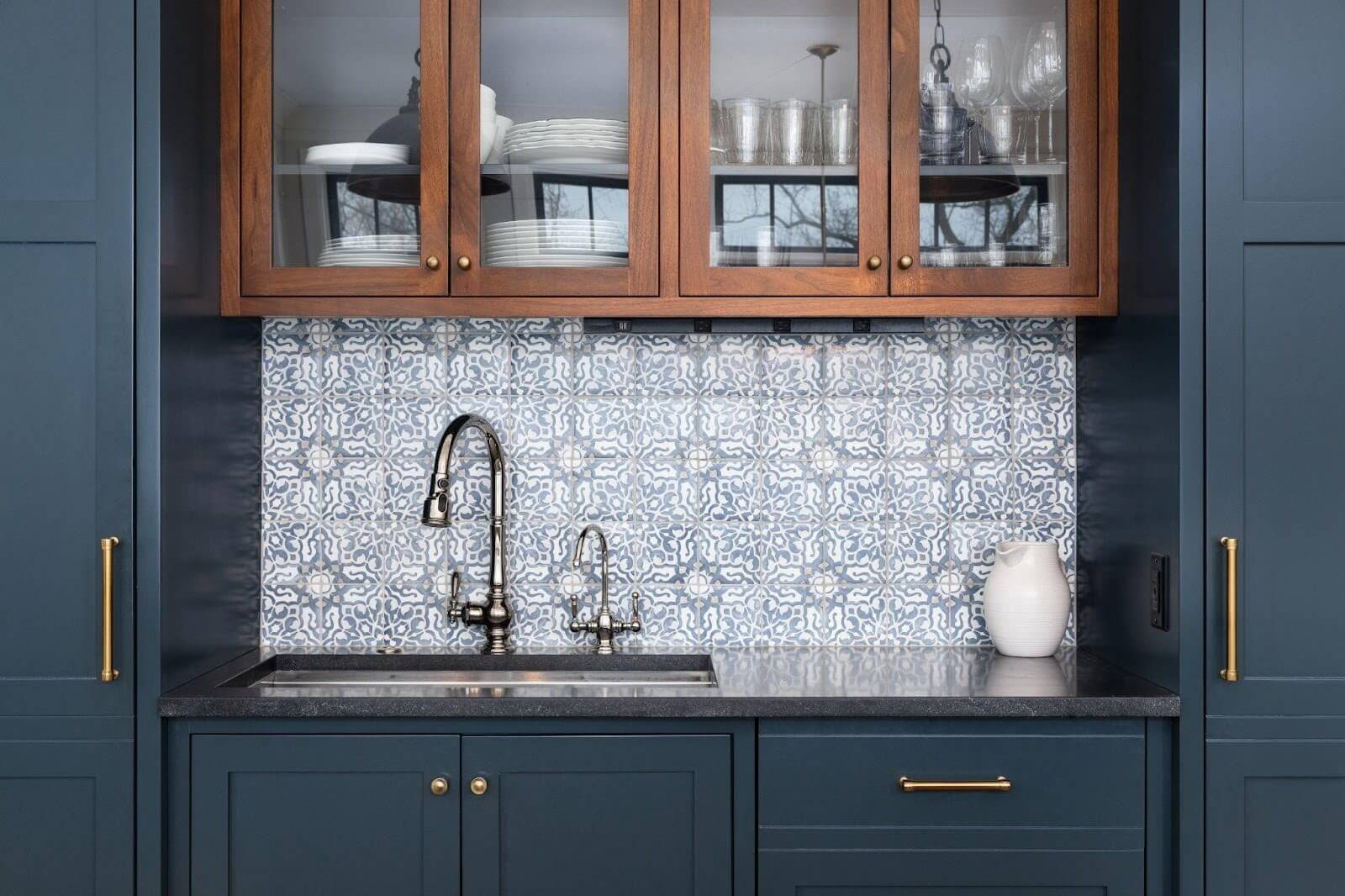 Kitchen interior showcasing blue cabinetry and a sleek sink area